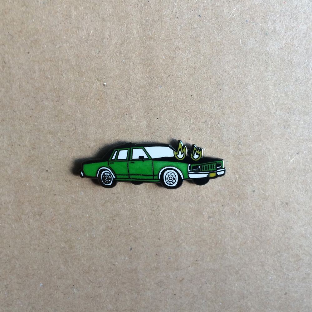 Product shots of Corey Purvis - Burning Car Enamel Pin