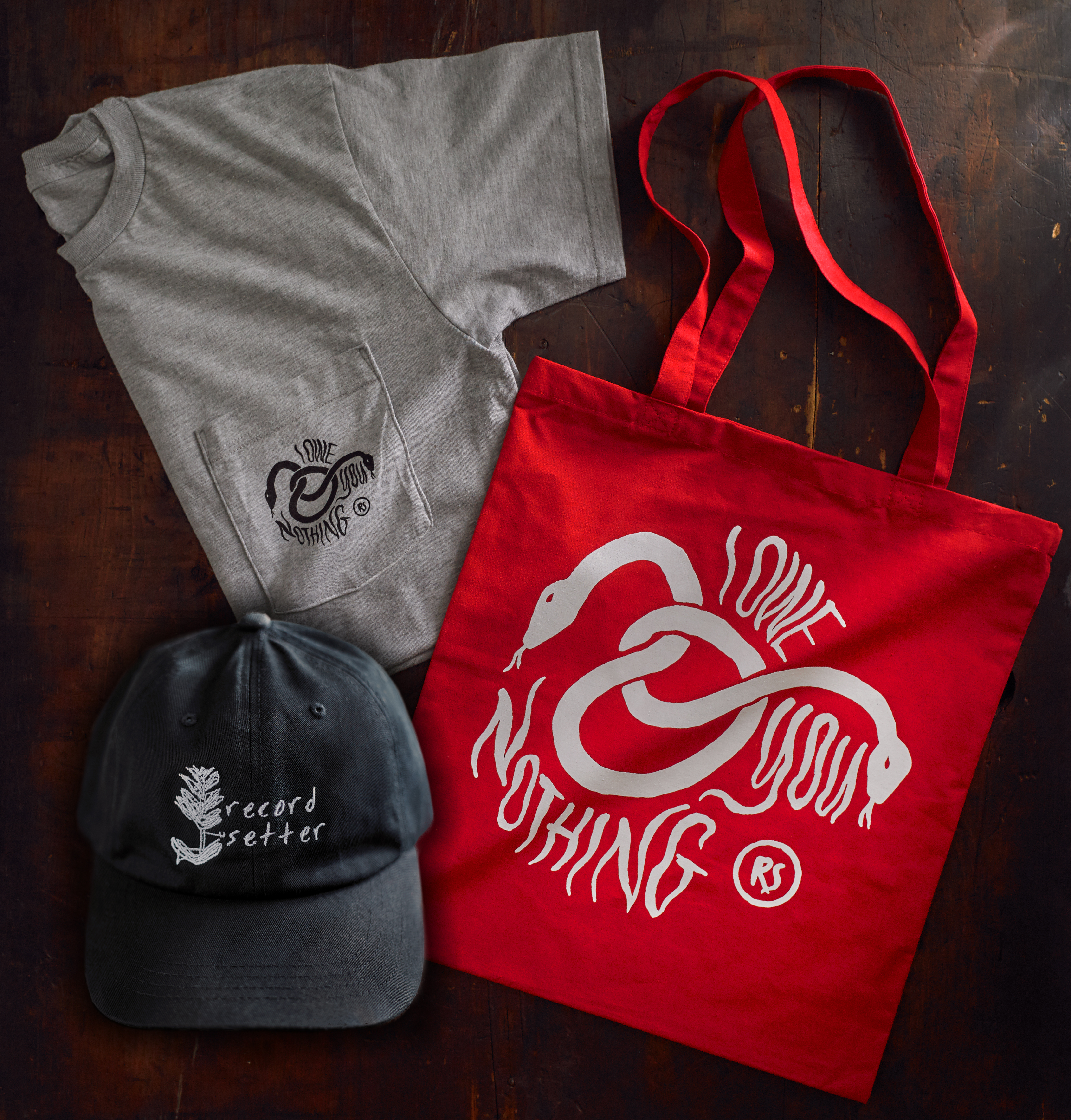 Product shots of Record Setter - IOYN Shirt + Hat + Tote Bundle