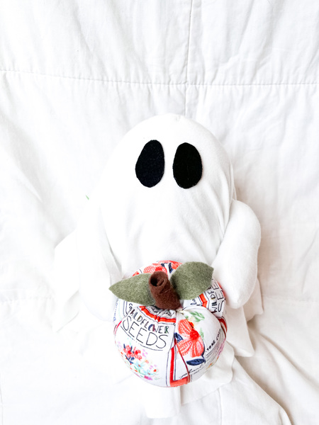 Ghost Holding Garden Themed Pumpkin